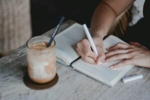 Person writing on white paper